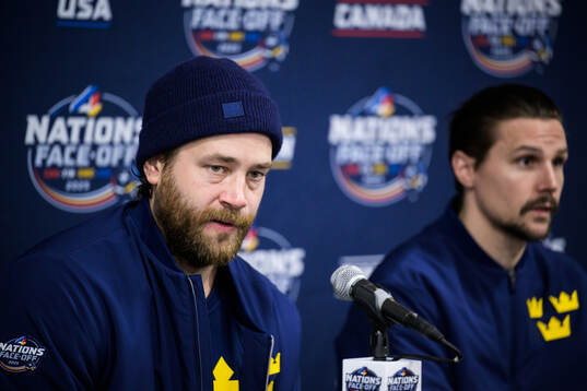Victor Hedman and Erik Karlsson of Sweden are being