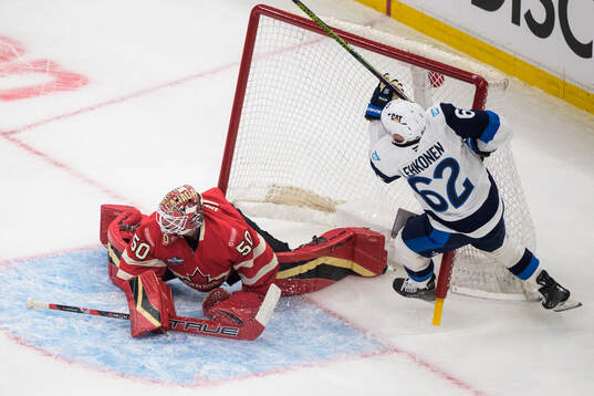 Goaltender Jordan Binnington of Canada and Artturi Lehkonen