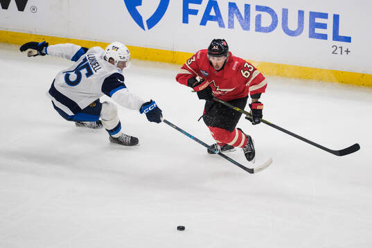 Anton Lundell of Finland and Brad Marchand of Canada