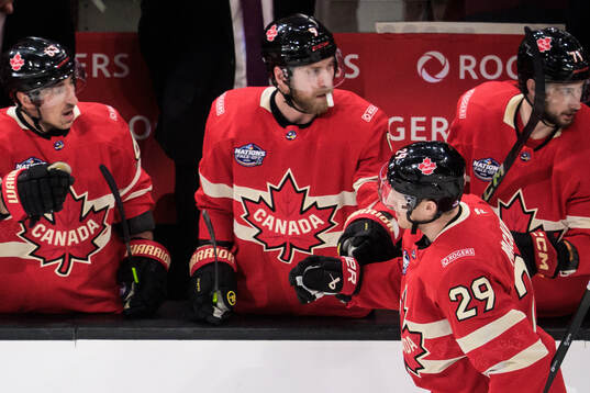 Nathan MacKinnon of Canada celebrates with teammates