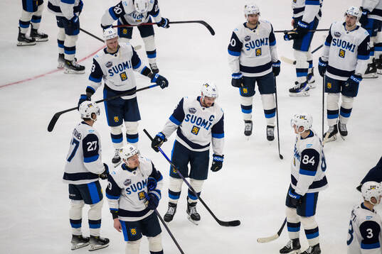 Aleksander Barkov and his teammates of Finland look dejected