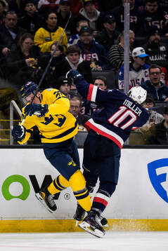 Joel Eriksson Ek of Sweden is tackled by J.T. Miller of USA