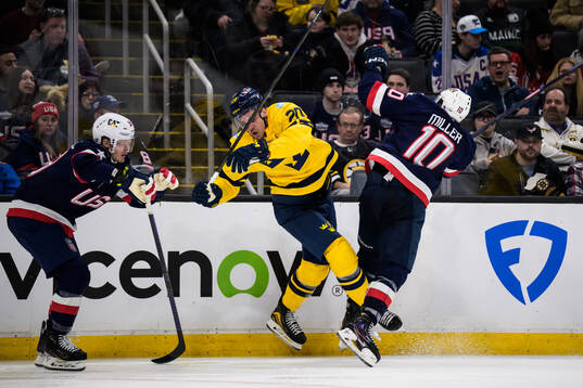Joel Eriksson Ek of Sweden is tackled by J.T. Miller of USA