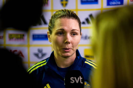 Goalkeeper Jennifer Falk is interviewed by the media