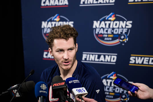 Matthew Tkachuk of USA is being interviewed by media