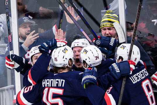 Brady Tkachuk of USA celebrates with teammates