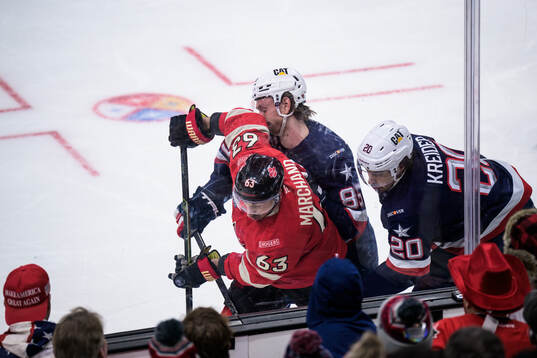 Brad Marchand of Canada in action against Jake Sanderson