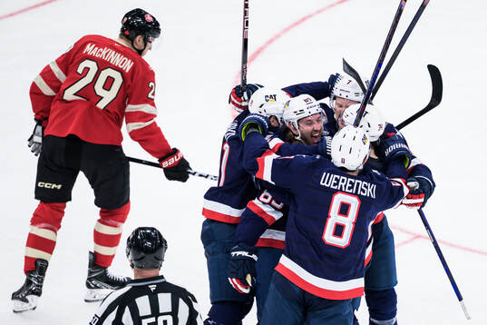 Jake Sanderson of USA celebrates with teammates