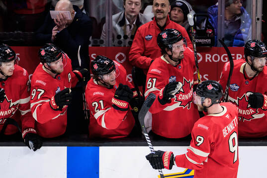 Sam Bennett of Canada celebrates with teammates