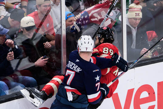 Brady Tkachuk of USA tackles Drew Doughty of Canada