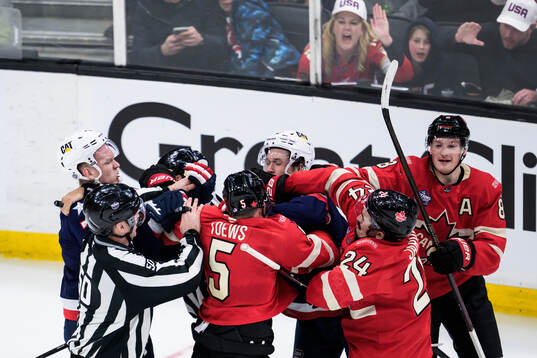 Brady Tkachuk and Matt Boldy of USA against Devon Toews,