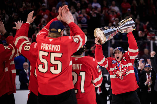 Sidney Crosby of Canada hoists the champion’s trophy
