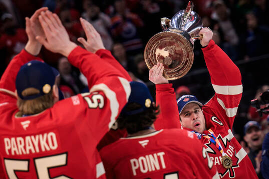 Sidney Crosby of Canada hoists the champion’s trophy