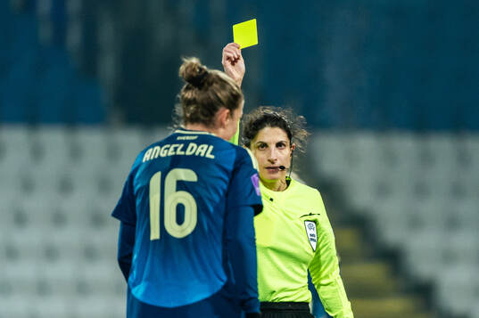 Filippa Angeldahl of Sweden is shown a yellow card from
