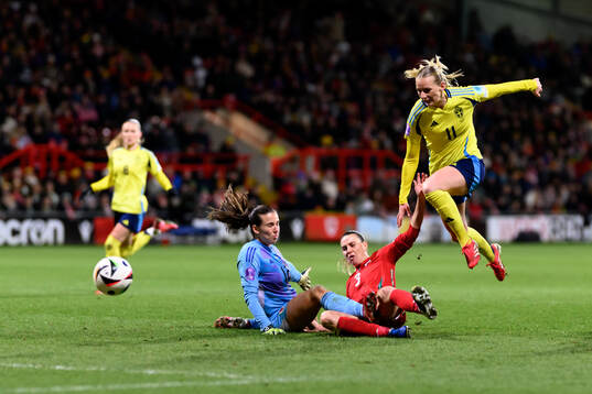 goalkeeper Olivia Clark and Gemma Evans of Wales against
