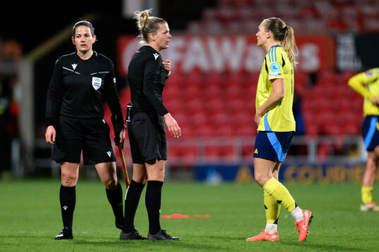 Referee Désirée Grundbacher speaks with Magdalena