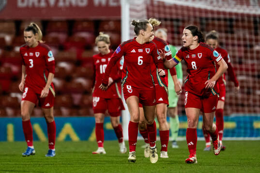 Josie Green and Angharad James of Wales celebrate