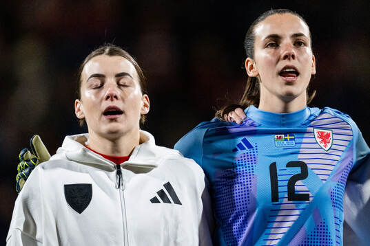 Angharad James and goalkeeper Olivia Clark of Wales