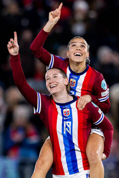 Elisabeth Terland of Norway celebrates with teammate Celin