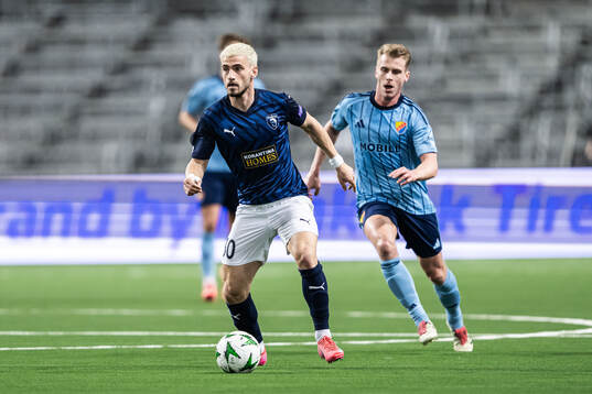 Vlad Dragomir of Pafos and Rasmus Schuller of Djurgården