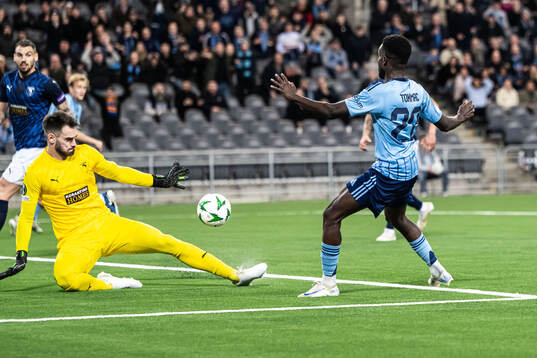 Goalkeeper Ivica Ivusic of Pafos and Tokmac Nguen of