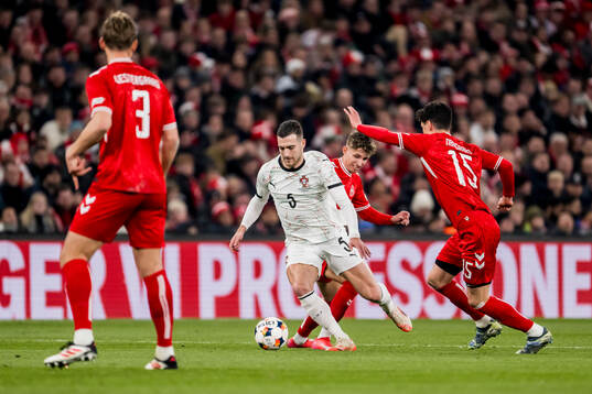 Diogo Dalot of Portugal and Christian Nørgaard of Denmark