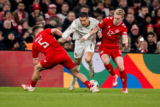 Joakim Mæhle and Mika Biereth of Denmark and Cristiano