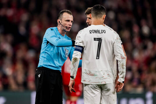 Referee Irfan Peljto and Cristiano Ronaldo of Portugal