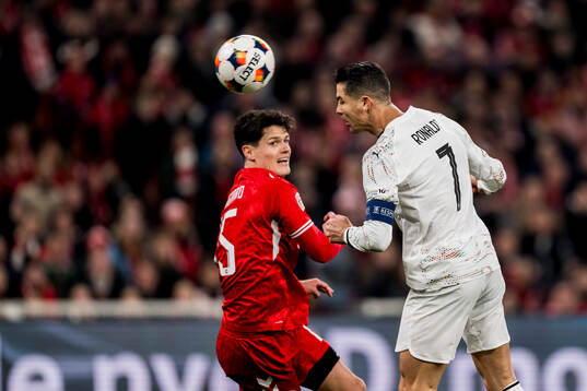 Christian Nørgaard of Denmark and Cristiano Ronaldo of