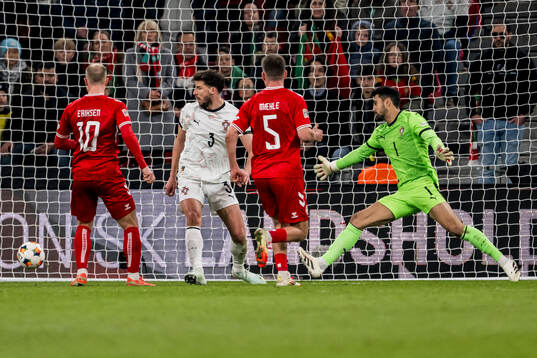 Christian Eriksen of Denmark and goalkeeper Diogo Costa of