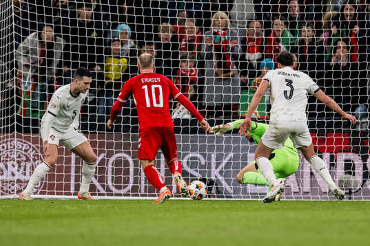 Christian Eriksen of Denmark and goalkeeper Diogo Costa of