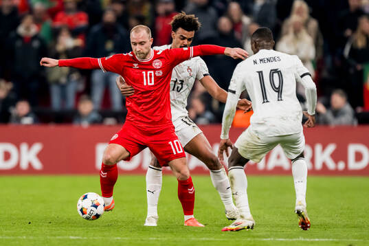 Christian Eriksen of Denmark and Renato Veiga of Portugal