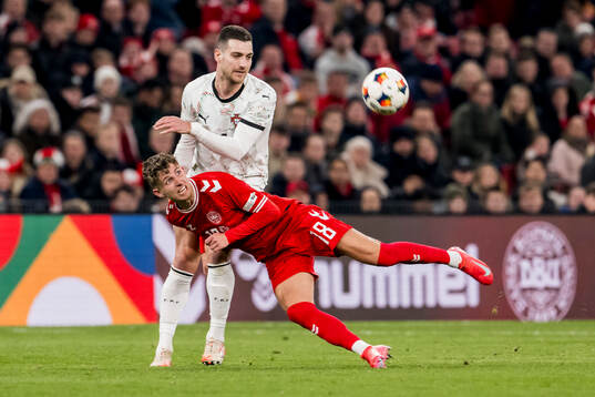Diogo Dalot of Portugal and Jesper Lindstrøm of Denmark