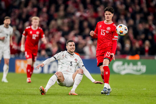 Diogo Dalot of Portugal and Christian Nørgaard of Denmark