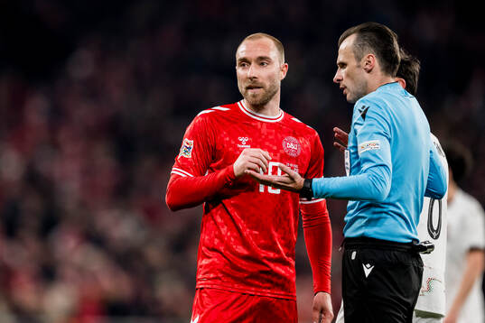 Christian Eriksen of Denmark and referee Irfan Peljto