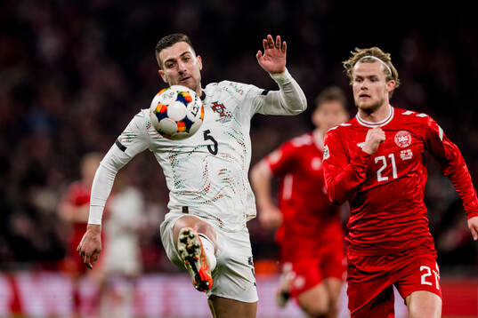 Diogo Dalot of Portugal and Morten Hjulmand of Denmark