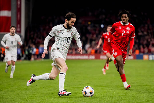 Bernardo Silva of Portugal and Patrick Dorgu of Denmark