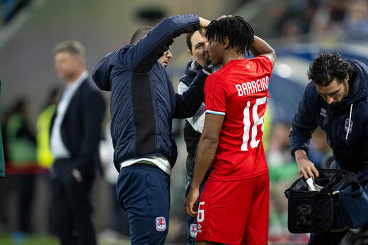 Leandro Barreiro of Luxembourg receives medical attention