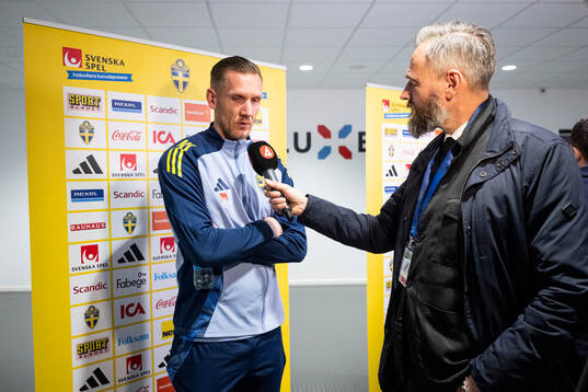Goalkeeper Robin Olsen of Sweden and sport reporter Olof