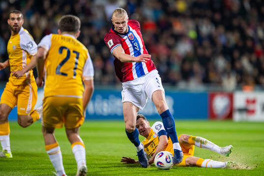 Erling Braut Haaland of Norway and Vadim Rata of Moldova