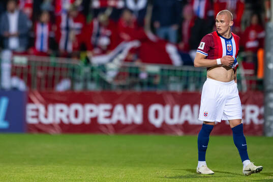 Leo Østigård of Norway walks off the pitch with an injury