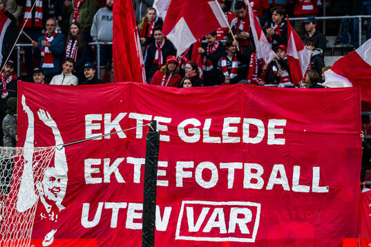Spectators in the stands with a anti VAR banner