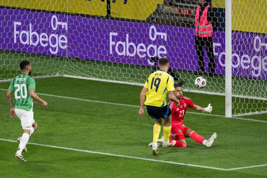 Emil Holm of Sweden scores the 1-0 goal against goalkeeper