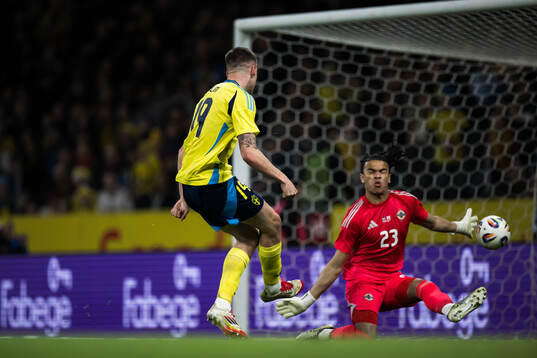 Emil Holm of Sweden scores the 1-0 goal against goalkeeper