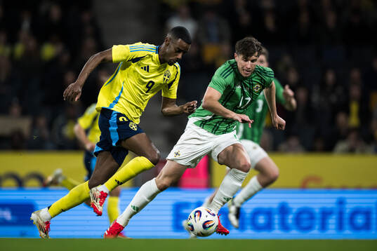 Alexander Isak of Sweden and Paddy McNair of Northern