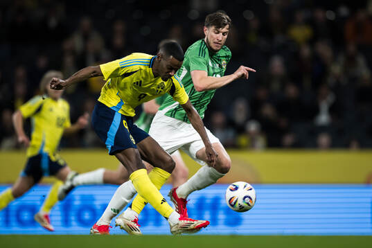 Alexander Isak of Sweden and Paddy McNair of Northern