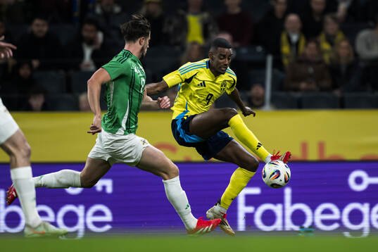 Paddy McNair of Northern Ireland and Alexander Isak of