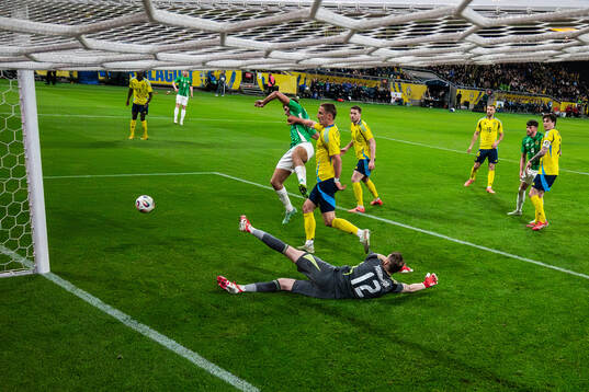 Callum Marshall of Northern Ireland is being pushed away by
