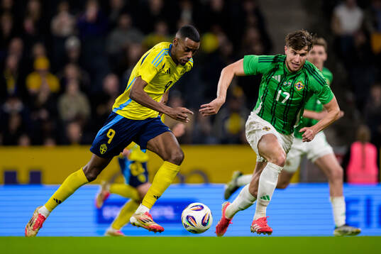 Alexander Isak of Sweden and Paddy McNair of Northern