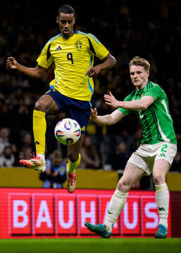 Alexander Isak of Sweden and Terry Devlin of Northern